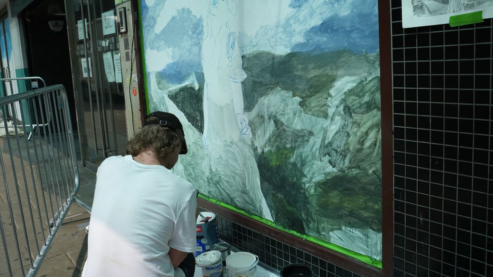 An artist painting a wall