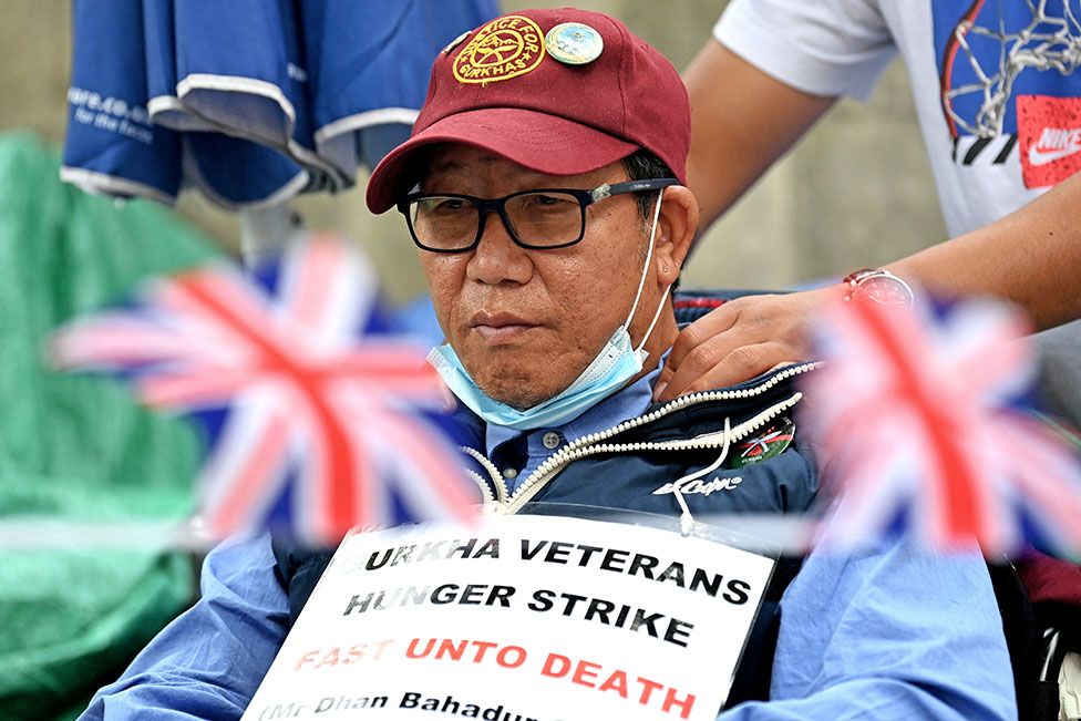 Protester Dhan Gurung receives a shoulder massage as he participates in a hunger strike for equal pensions for Gurkha veterans outside Downing Street in London