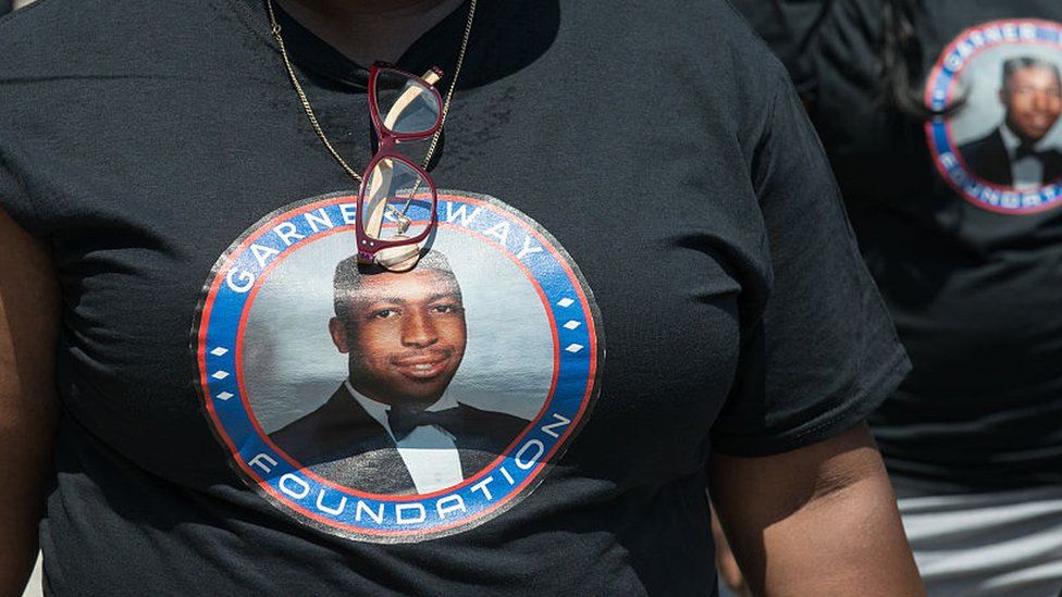 People wear t-shirts commemorating the two year anniversary of Eric Garner's death during a march on 16 July, 2016