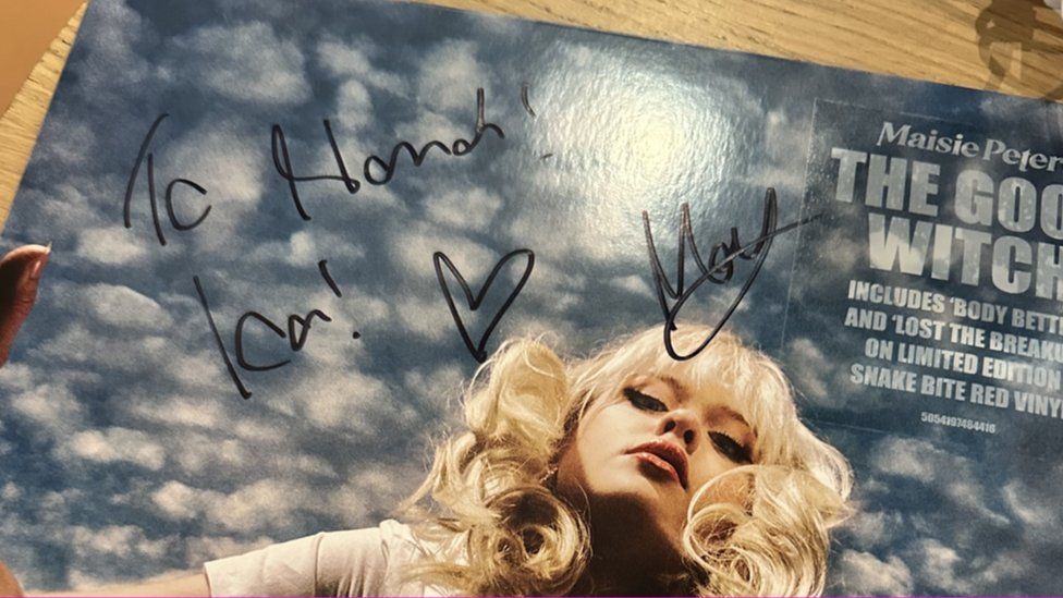 A close-up photo of the cover of Maisie Peters' vinyl album The Good Witch which she has signed andquot;To Hannah" and has kisses and a heart drawn on it as well as her signature.