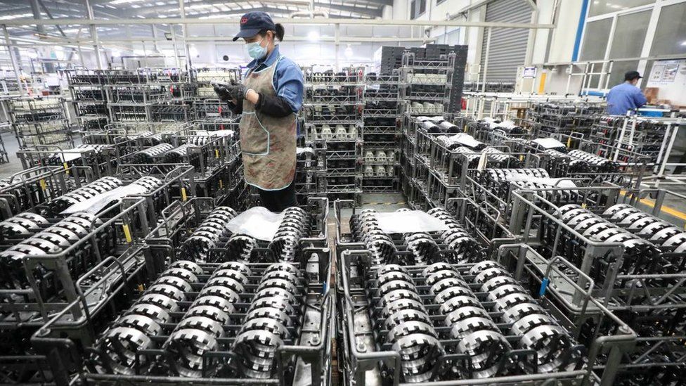 An employee works on the production line of gear wheel at a factory of Zhejiang Shuanghuan Driveline.