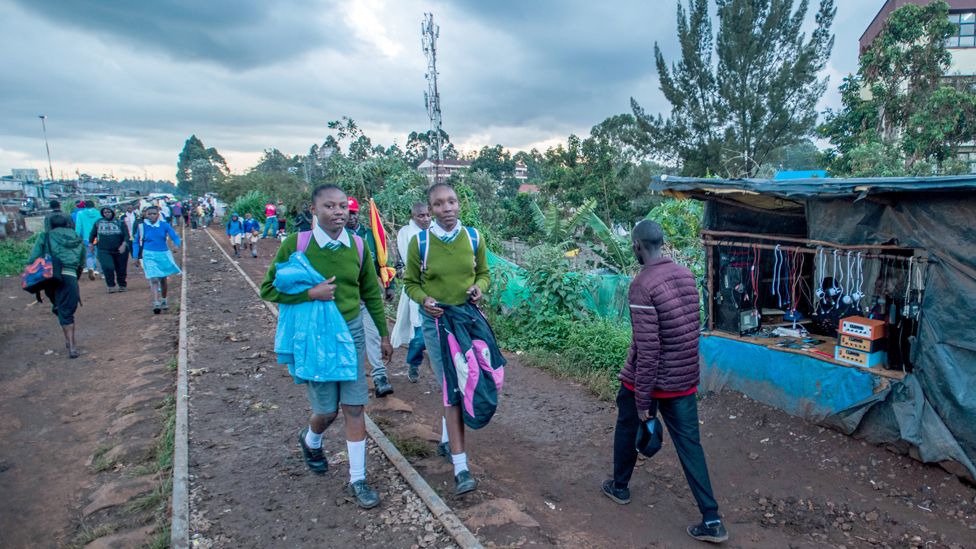 Students walk on the train tracks in Nairobi, Kenya - Tuesday 9 May 2023