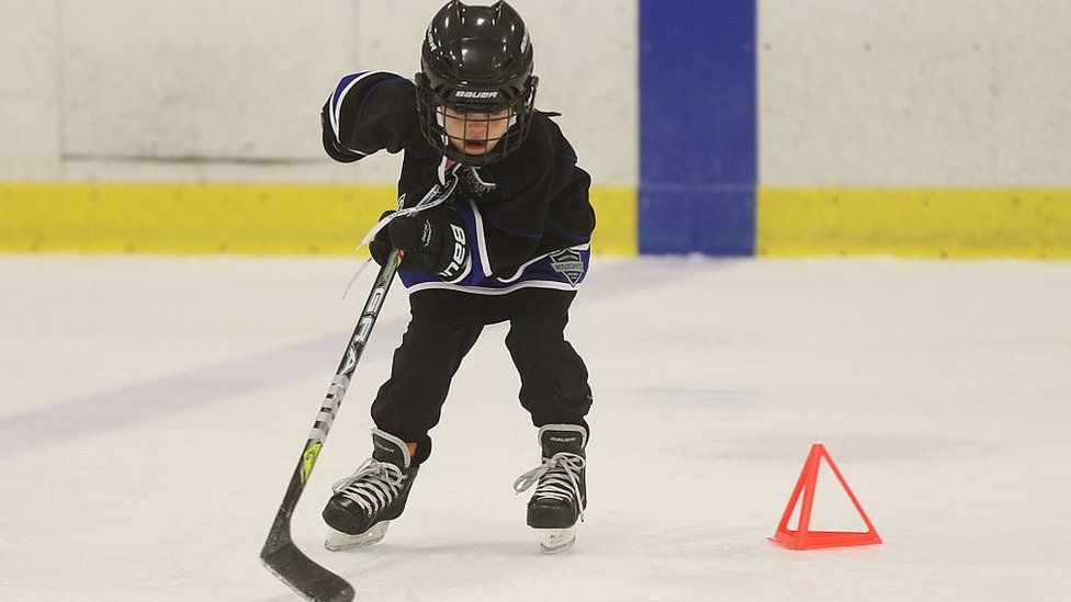 Child doing hockey drills