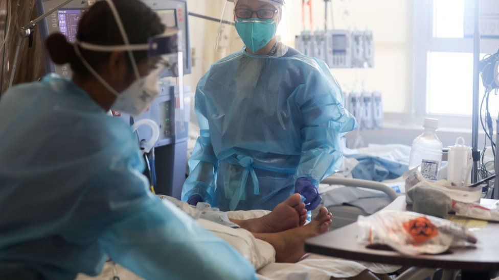 На изображении показаны медсестры, ухаживающие за пациентами с Covid-19 в Калифорнии