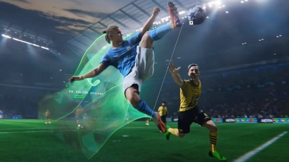 A computer-generated version of Erling Haaland, in Manchester City's sky blue home strip, leaps for the ball in the middle of a match in EA Sports FC 24. He's in mid-air, in a karate kick-style pose and has one leg stretching out his orange football boot to make contact with the ball. A bright green vapour trail emanates behind him, showing the path he's followed. Another player is nearby and looks desperate as he tries to intercept Haaland.