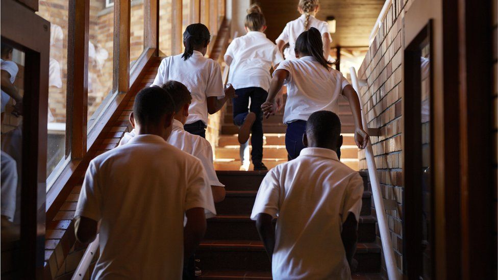 School childern running up stairs in school