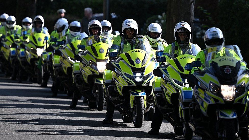 a line of police officers on motorbikes