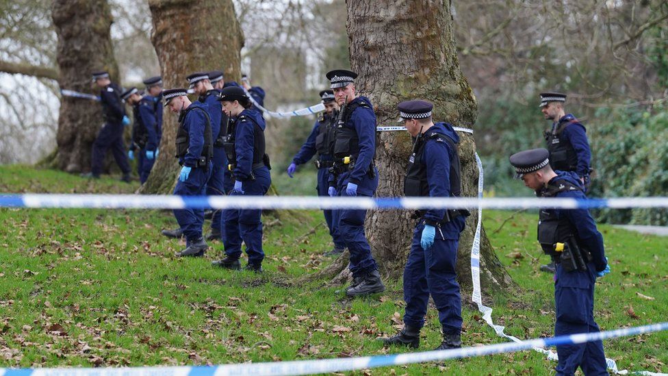 Police officers conduct a fingertip search on Primrose Hill, Camden