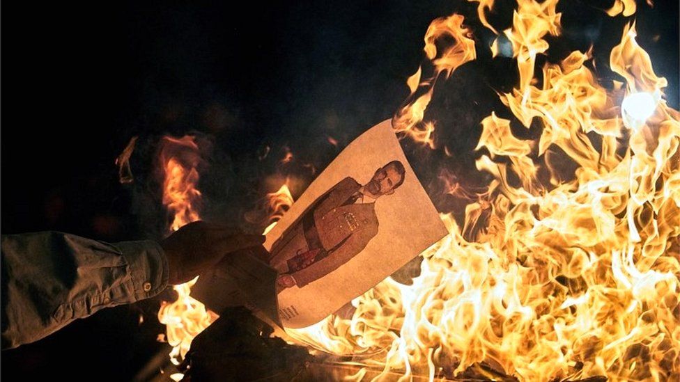 Catalan pro-independence protesters burn a picture of Spain's King Felipe VI in Catalonia on 4 November 2019