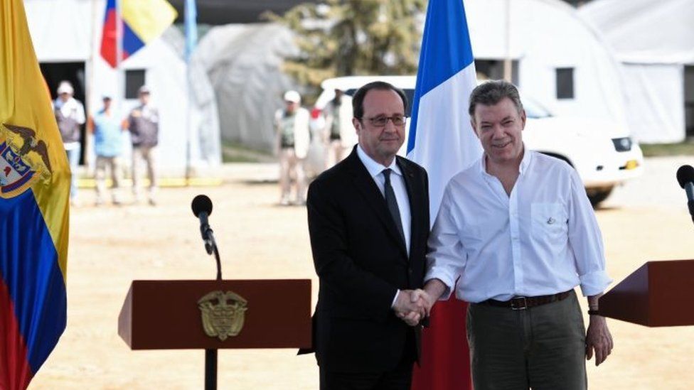 Colombian President Juan Manuel Santos (R) and French President Francois Hollande shake hands after delivering a joint press conference in Caldono, Valle del cauca department, Colombia on January 24, 2017