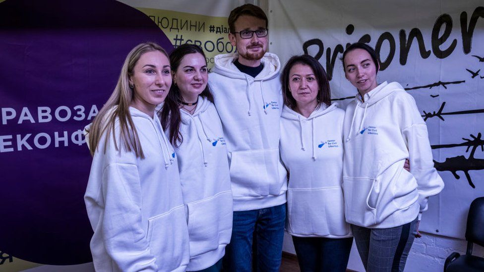 Staff members of the Centre for Civil Liberty pose for a photo and celebrate in their office on October 7, 2022 in Kyiv, Ukraine