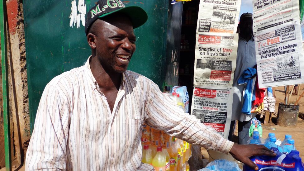 Cameroonian street vendor Peter Nkemashi by his kiosk in Yaounde. Photo: Randy Joe Saah, BBC Africa