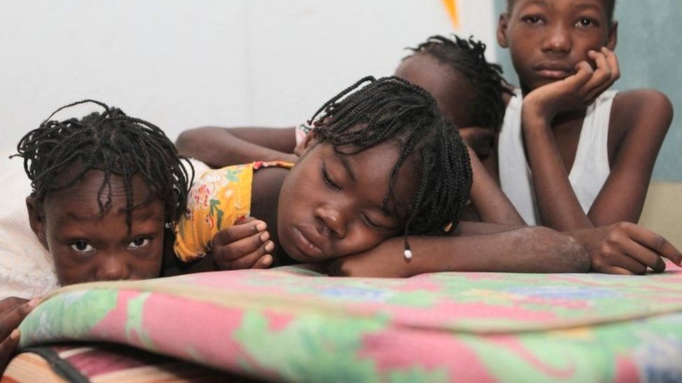 Haitian children who escaped violence in the town of Cite-Soleil are seen as they take refuge at a school