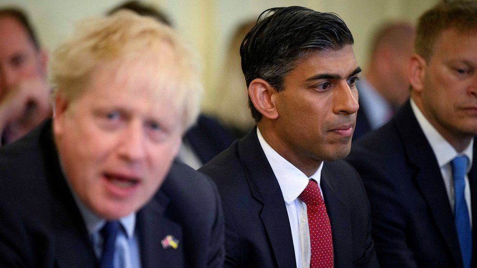 A close-up photo of Boris Johnson and Rishi Sunak at a cabinet meeting