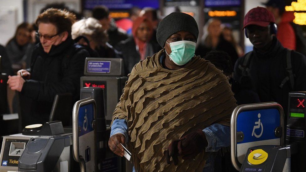 A passenger wears a face mask on the London Underground