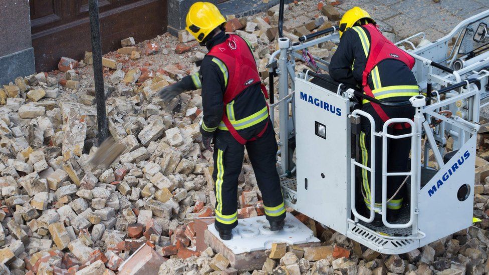 Members of the London fire brigade assess the damage at The Duchess pub in Battersea after Storm Katie's high winds brought down part of the building's roof support