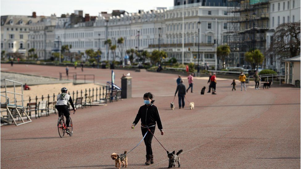 Dog walkers on Llandudno seafront amid the coronavirus pandemic