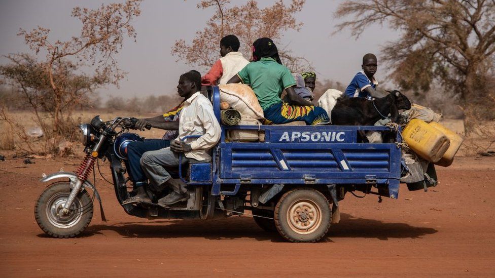 People with their belongings on a vehicle flee their villages, on the road from Barsalogho to Kaya on January 27, 2020