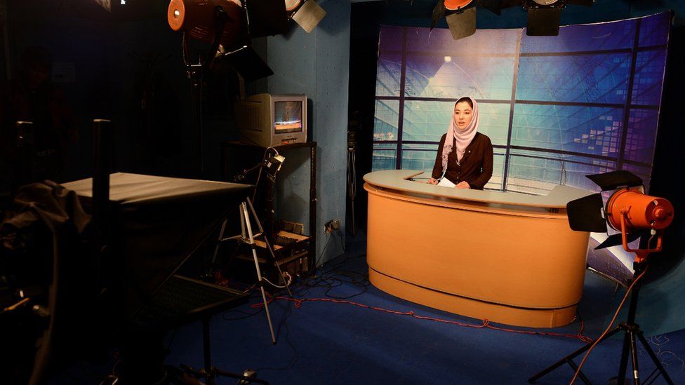 File photo: In this photograph taken on January 30, 2013 a female Afghan news presenter reads the news at a studio in Kabul.