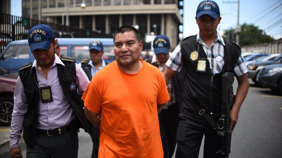 Former Guatemalan soldier Santos Lopez Alonzo escorted by Interpol agents after landing in Guatemala City, on August 10, 2016