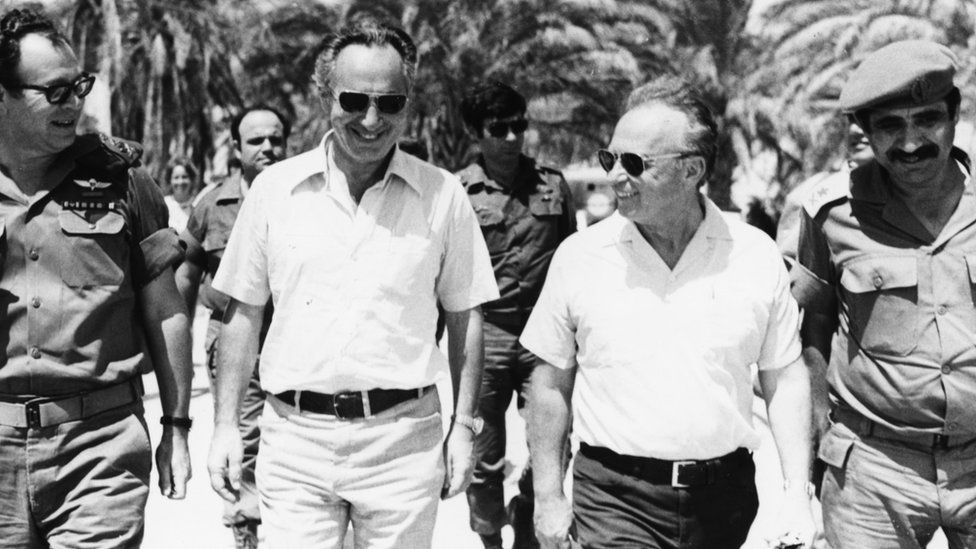 Israeli Prime Minister Yitzhak Rabin (second right) with Israeli politicians Shimon Peres (second left) and Mordechai Gur (left), and Deputy Chief of Staff General Yekutiel Adam (right), walking together during a tour of the forces on the Egyptian Front during the Six Day War, Sinai, June 1967