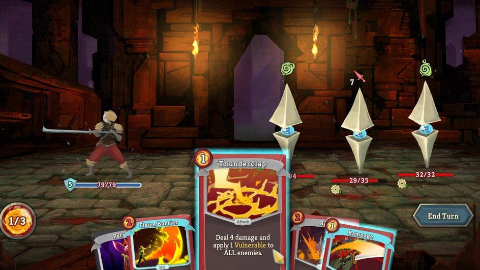 A screenshot from Slay the Spire showing the player character clad in armour and wielding a long, thin sword in front of a medieval castle with its drawbridge down. Three identical enemies - a blue orb with two pyramidal shapes attached are opposite, In the lower screen a card reading "Thunderclap: Deal 4 damage and apply 1 Vulnerable to All enemies" is visible
