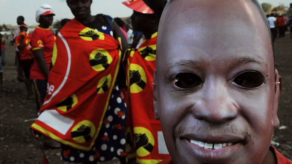 A supporter of the Jubilee Party of Kenya wears a mask of Kenyan President Uhuru Kenyatta as he attends a campaign rally in Nairobi on July 21, 2017 ahead of next month's presidential election.