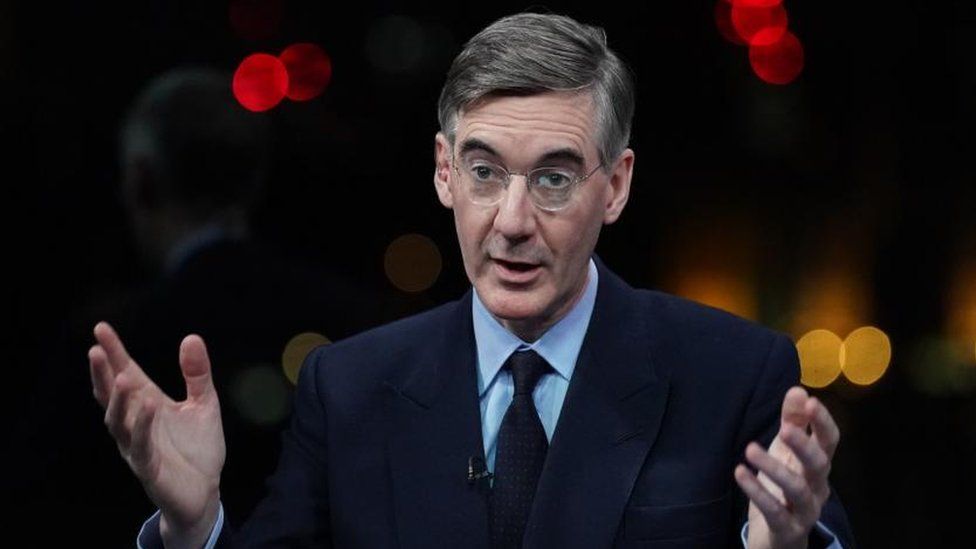 Jacob Rees-Mogg holding his hands up in a TV studio