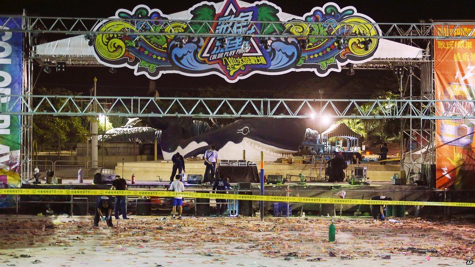 Police investigators inspect the stage area after an accidental explosion during a music concert at the Formosa Water Park in New Taipei City, Taiwan, early on Sunday