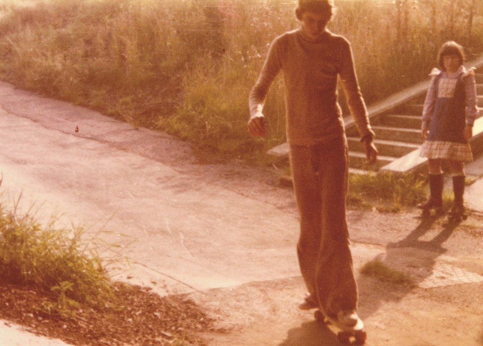 Boy skateboarding in 1970s