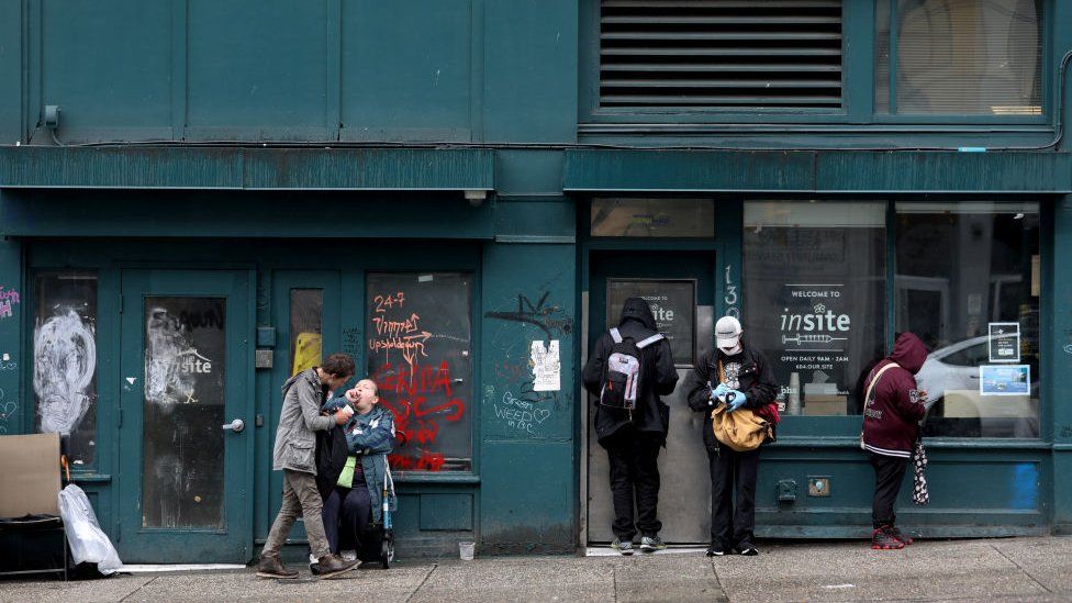 Clients wait outside of Insite, a supervised consumption site located in the Downtown Eastside (DTES) neighborhood of Vancouver