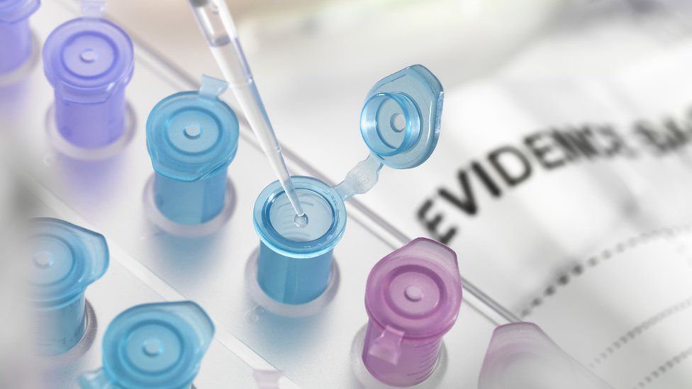 Stock photo of a coloured vial with a pipette,next to an evidence bag