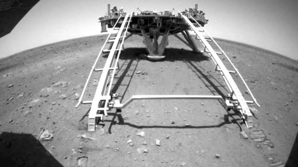Chinese rover Zhurong of the Tianwen-1 mission drives down the ramp of the lander onto the surface of Mars, in this screenshot taken from a video released by China National Space Administration (CNSA) on 22 May 2021