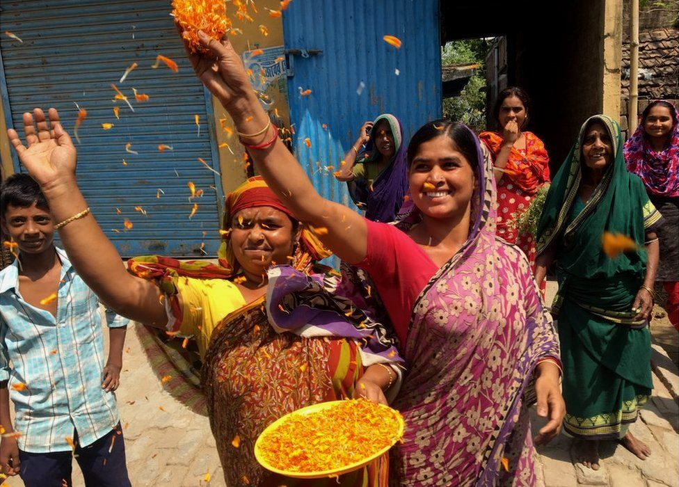 Women throw marigold petals at Mahua Moitra