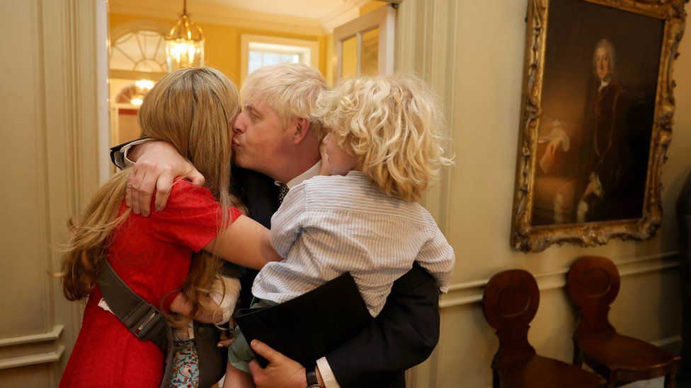 Boris Johnson is comforted by his wife Carrie and their children after delivering his statement in Downing Street
