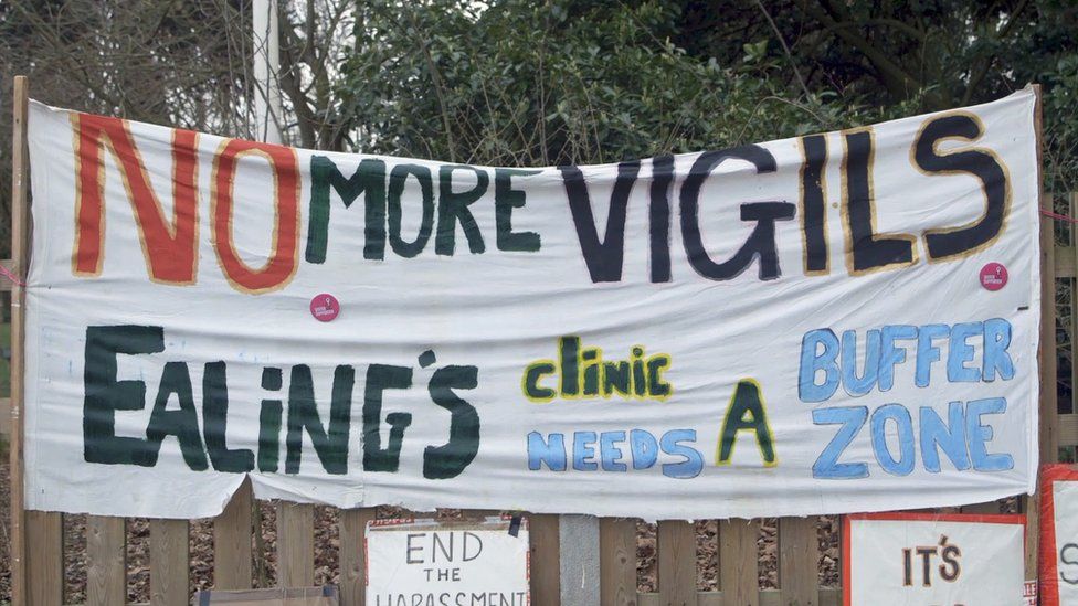 Banner that reads 'no more vigils' outside a clinic in Ealing