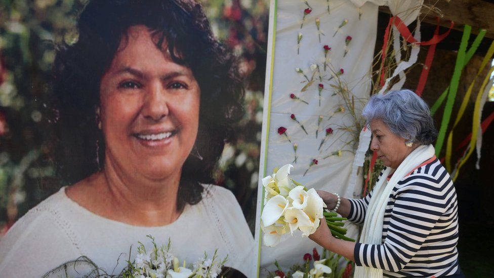 The president of the NGO Committee of Relatives of the Disappeared in Honduras (COFADEH), Bertha Oliva, lays a wreath on an alter in memory of murdered indigenous Honduran environmentalist Berta Caceres, in La Esperanza,