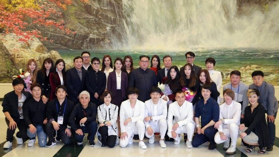 A picture released by the North Korean Central News Agency shows leader Kim Jong-un (C), together with his wife Ri Sol Ju, with South Korean artists at the East Pyongyang Grand Theatre, 1 April 2018