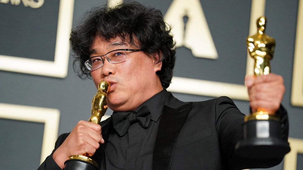 Bong Joon-ho, winner of the Original Screenplay, International Feature Film, Directing, and Best Picture award for Parasite, poses in the press room during the 92nd Annual Academy Awards