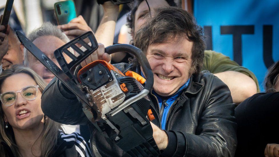 Presidential candidate Javier Milei lifts a chainsaw during a rally on 25 September 2023 in San Martin, Buenos Aires, Argentina