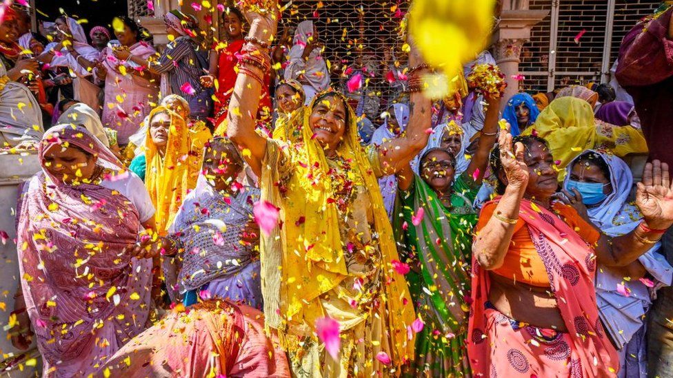 Widows throw petals and Flowers while participating in the Holi festival at Gopinath Temple on March 6, 2023 in Vrindavan, India.