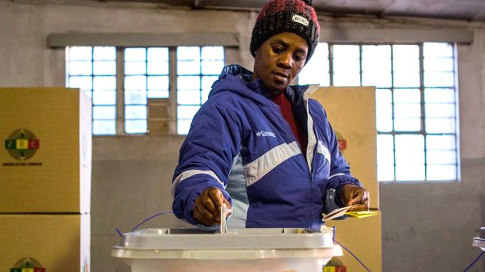 A woman casts her vote at Stanley Hall polling station in the township of Makokoba on July 30, 2018