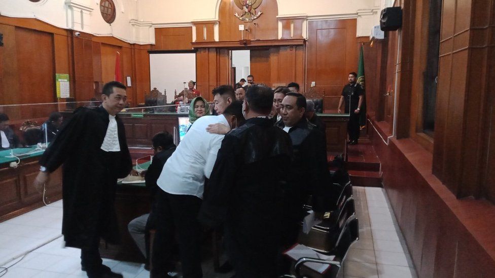 One of defendants, Bambang Sidik Achmadi, embraced his attorney after being declared free at the Surabaya District Court, East Java.