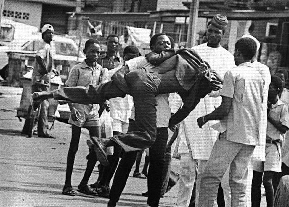 A photo by Sunmi Smart-Cole entitled: "Meanwhile In Lagos" - 1985, showing a street fight