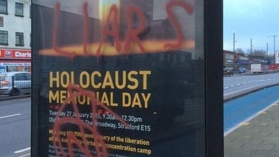 Poster advertising a Holocaust memorial event in east London daubed with graffiti including the words "liars" and "killer"