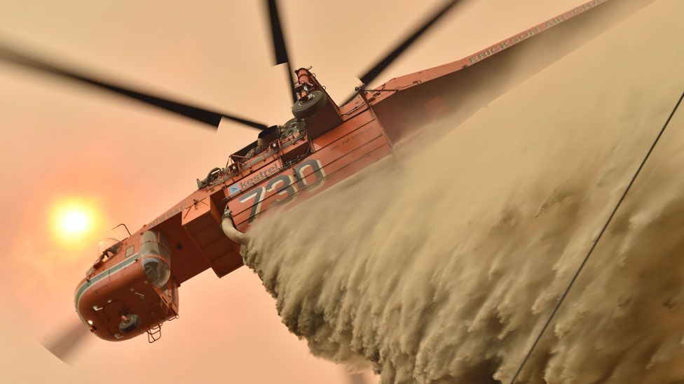 A helicopter drops fire retardant in Balmoral, 150 kilometres southwest of Sydney