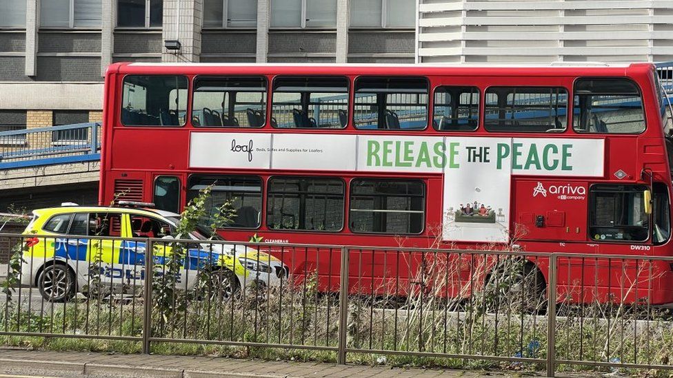 Image showing a police car parked in front of a red bus on Wellesley Road, Croydon.