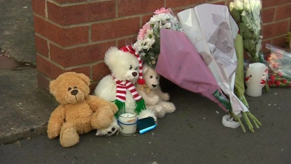 Cuddly toys and flowers outside Alex Robinson's home
