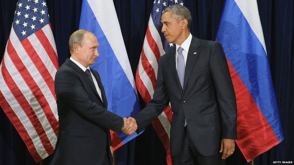 Vladimir Putin shakes hands with Barack Obama