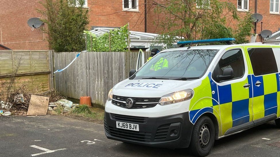 A police van parked near parking spaces on a residential estate.